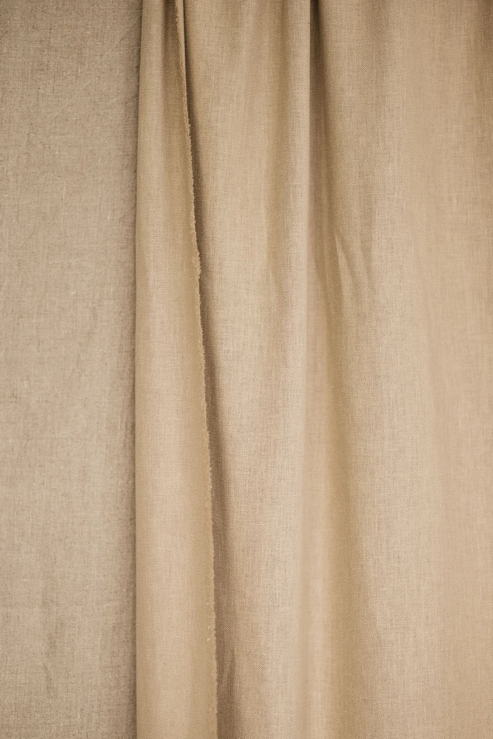 Beige linen curtain showing the weave and fall of the fabric